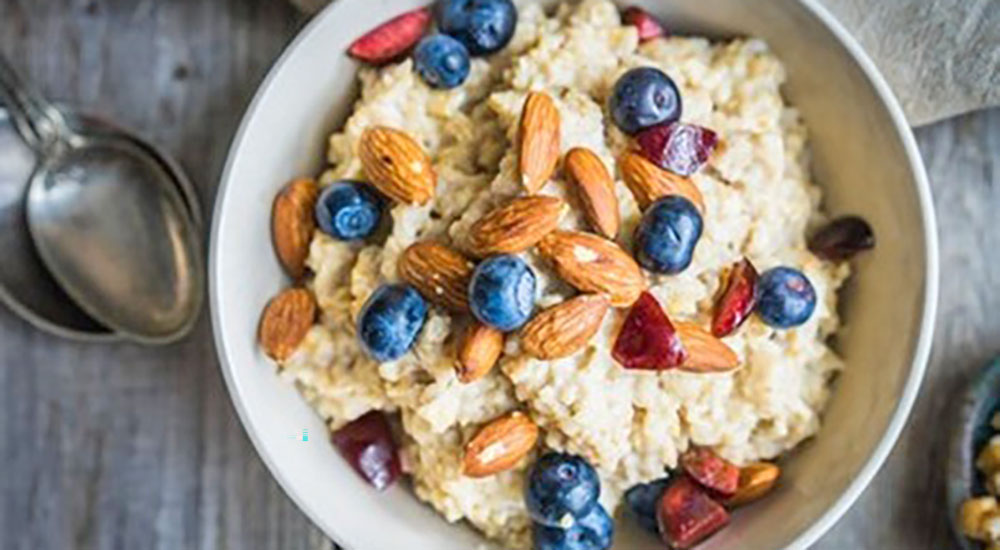 Breakfast bowl of oatmeal with nuts and berries