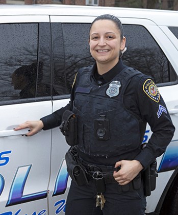 VA female police officer standing outside her vehicle