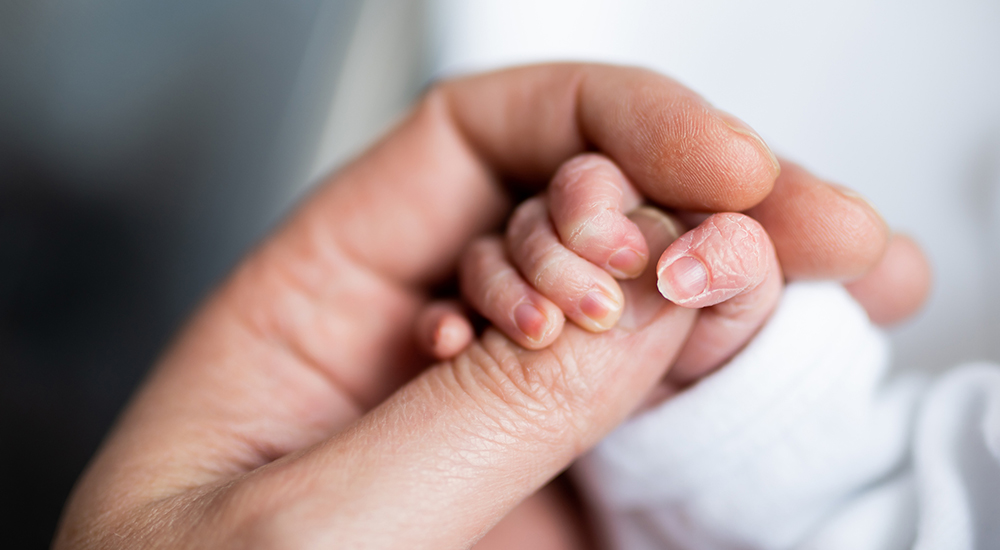 Baby fingers holding adult fingers; pregnant; babies