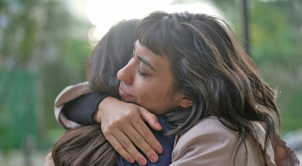 Woman hugging a friend; suicidal thoughts