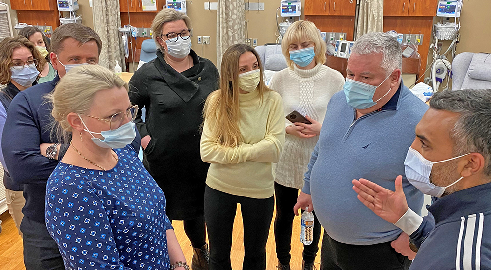 Doctor briefing large group of Ukrainian doctors