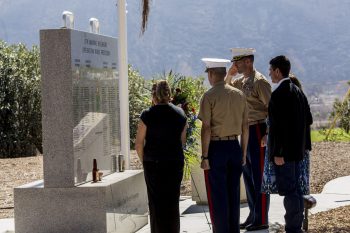 Marines and guests standing in front of memorial for fallen iraqi freedom veterans