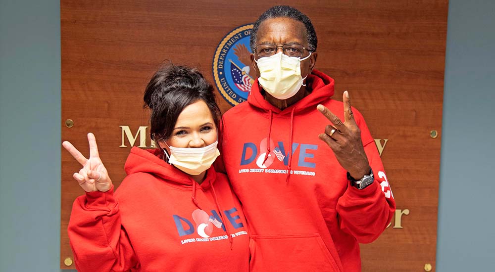 Man and woman giving V for victory signs; kidney donation