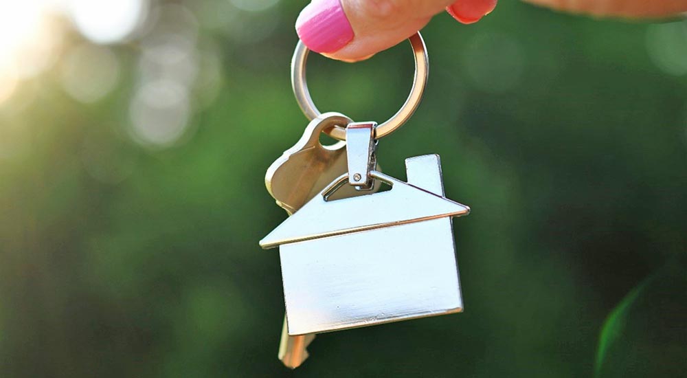 Homeless woman holding house key