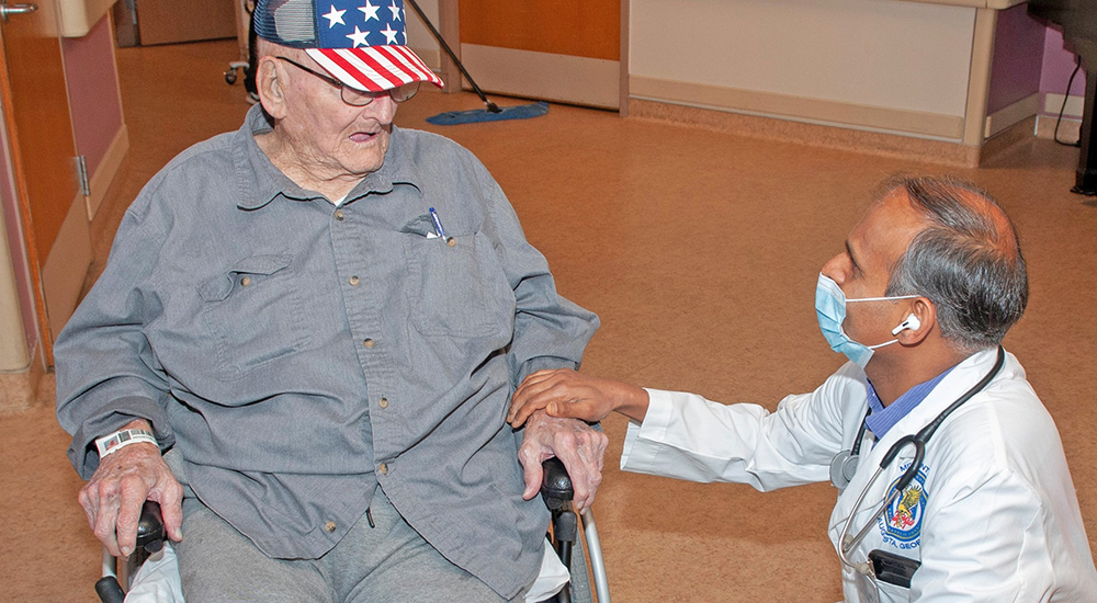 VA Augusta doctor with Veteran in wheelchair; saved boy’s life