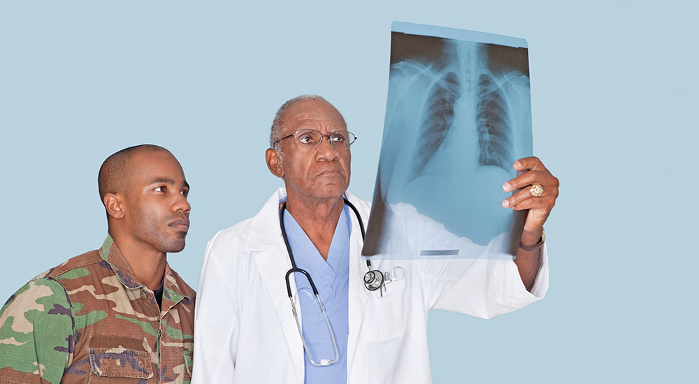 Doctor and soldier looking at x-ray; respiratory health