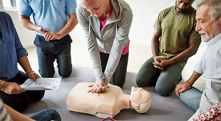 A person practicing CPR on a mannequin   