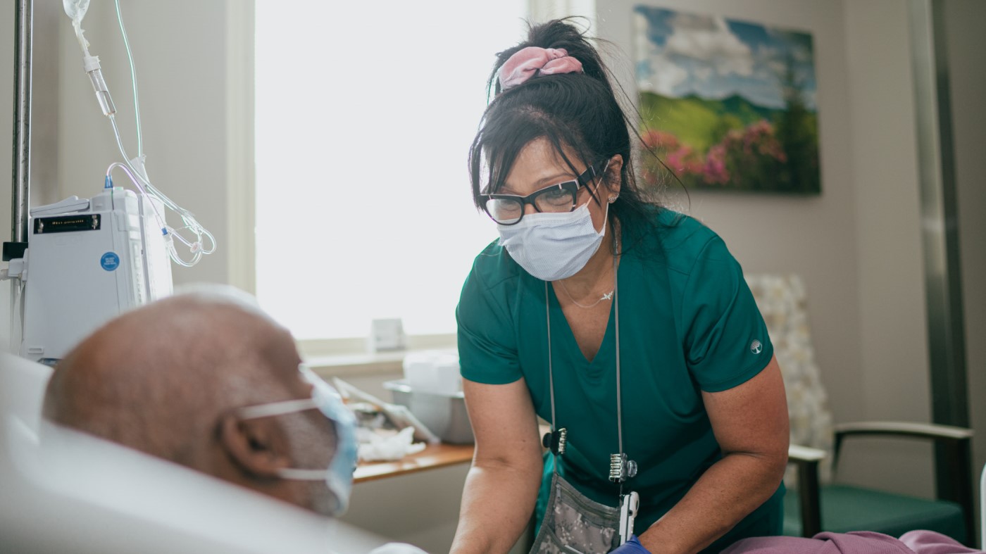 A VA nurse assists a Veteran patient in a VA Medical Center.