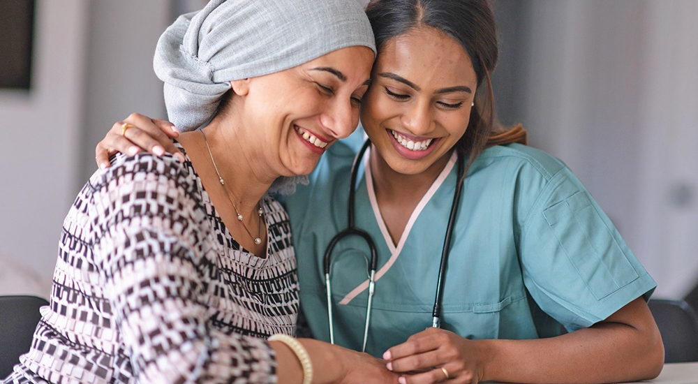 Women health care nurse and patient embrace