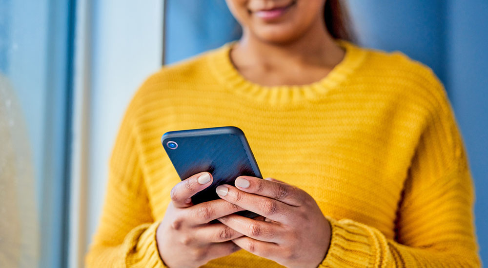 Compassionate Care Corps woman with phone; loneliness