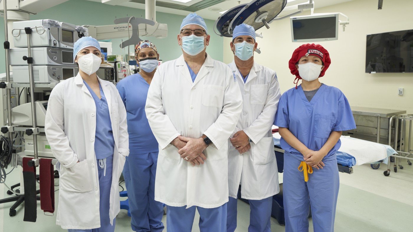 Members of a VA surgical team stand in an operating theater.