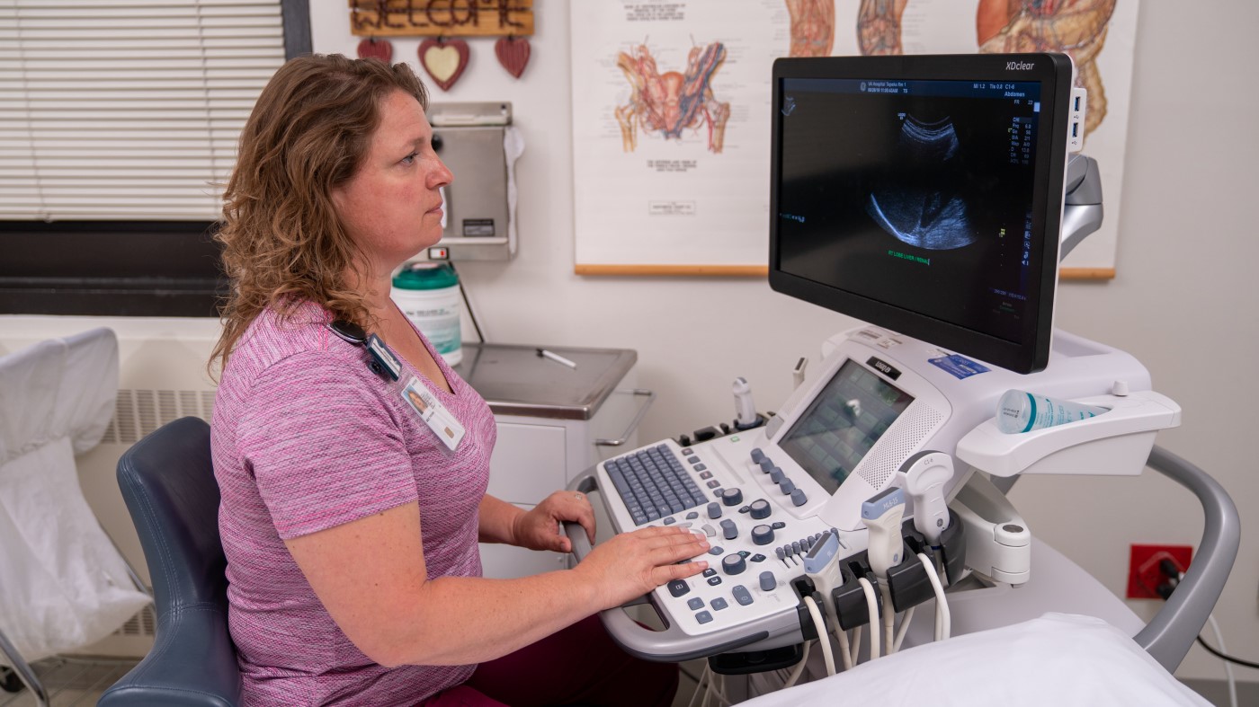 A VA medical instrument technician examines an ultrasound.