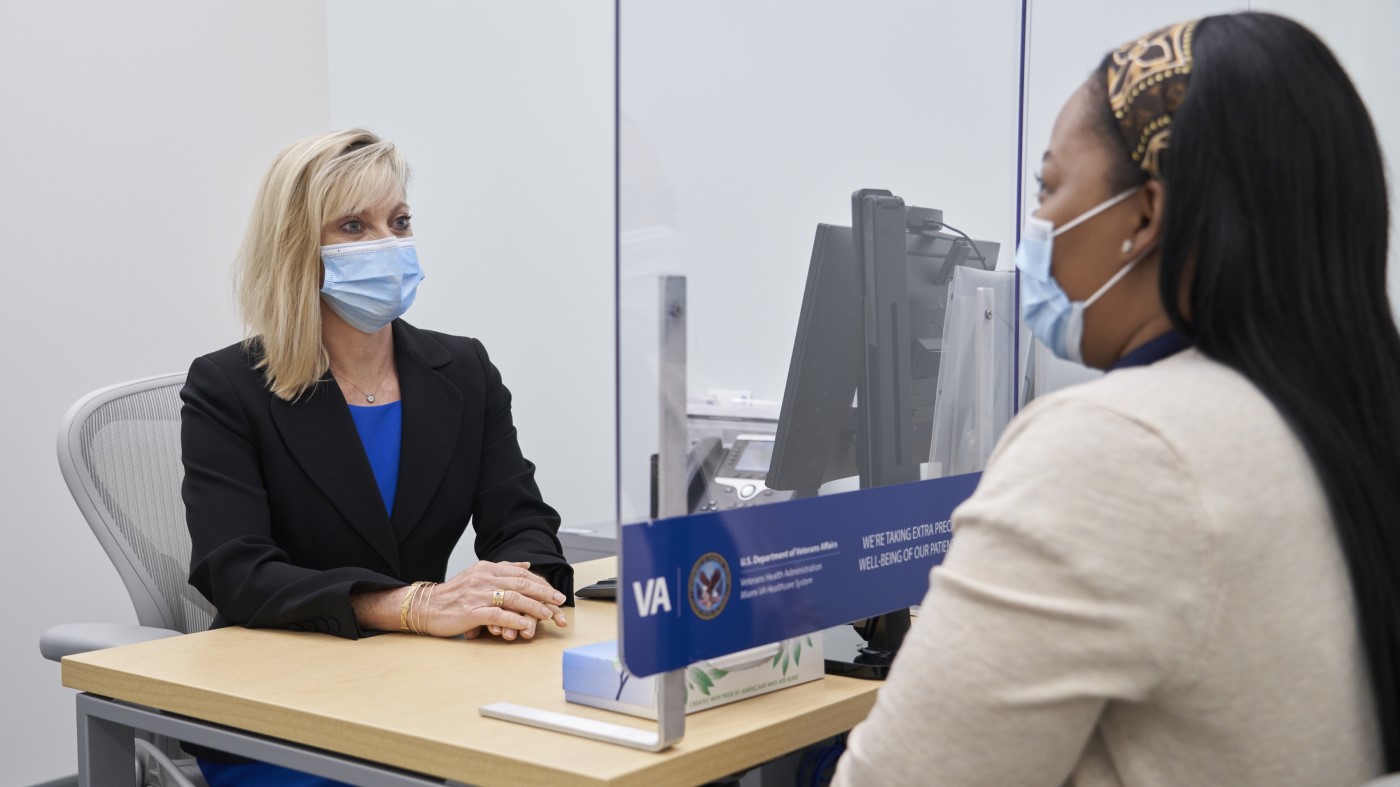 A human resources specialist discussion an application with an interviewee.