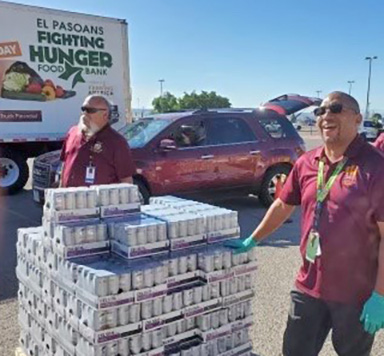 Men with supplies at food insecurity event