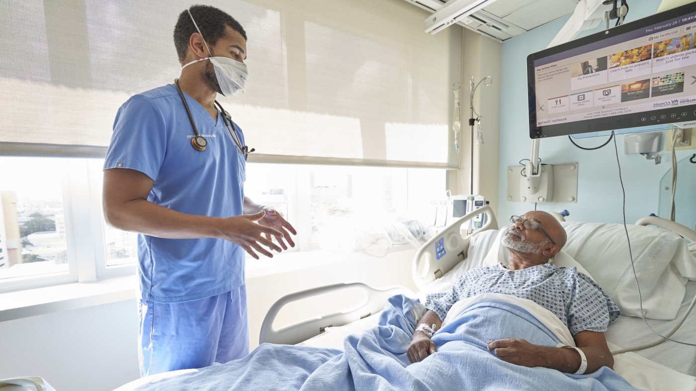 A VA physician working in emergency medicine discusses a diagnosis with a Veteran seeking treatment.