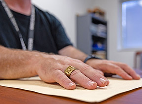 Hands of blind Veteran reading braille