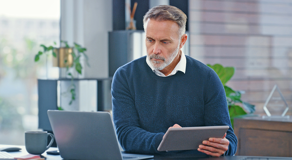 Man reading Mediflix information on laptop