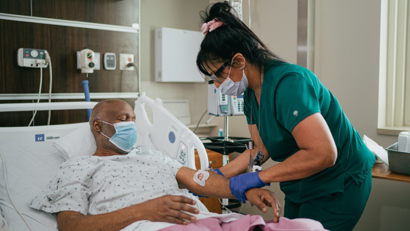 A nurse assists a Veteran patient at a VA facility.
