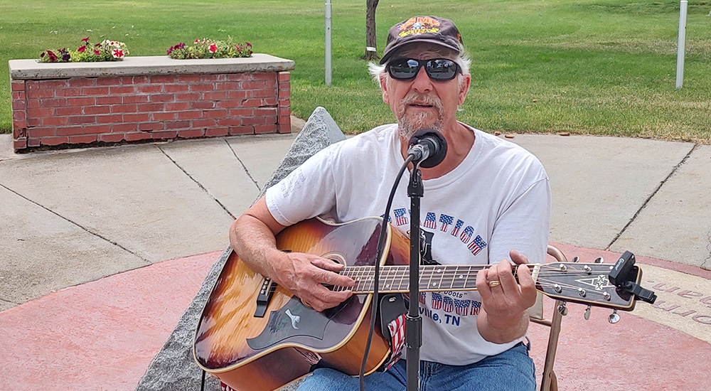 Volunteer plays guitar and sings