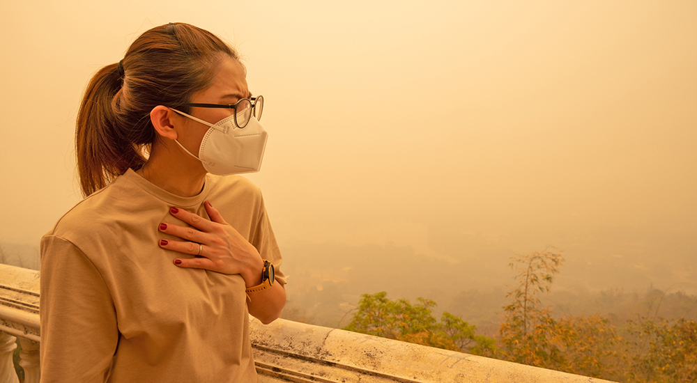 Woman in mask in bad air location