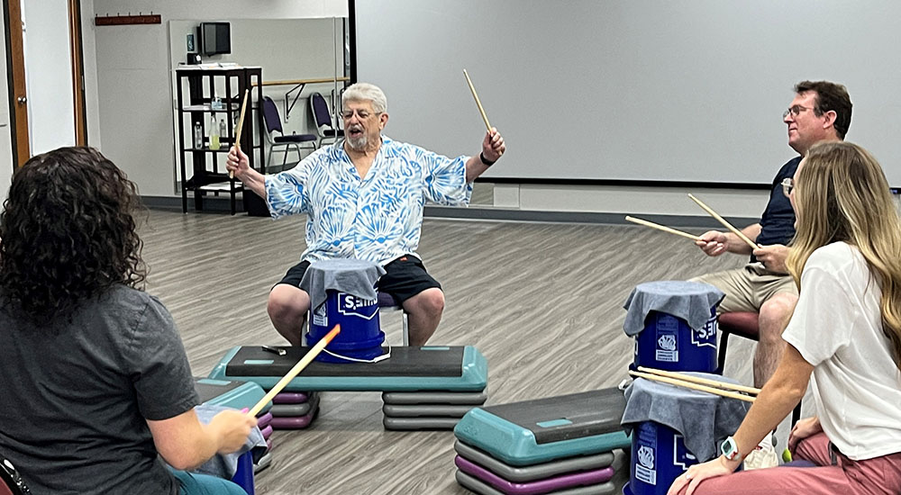 Veterans with Parkinson's in drumming therapy session
