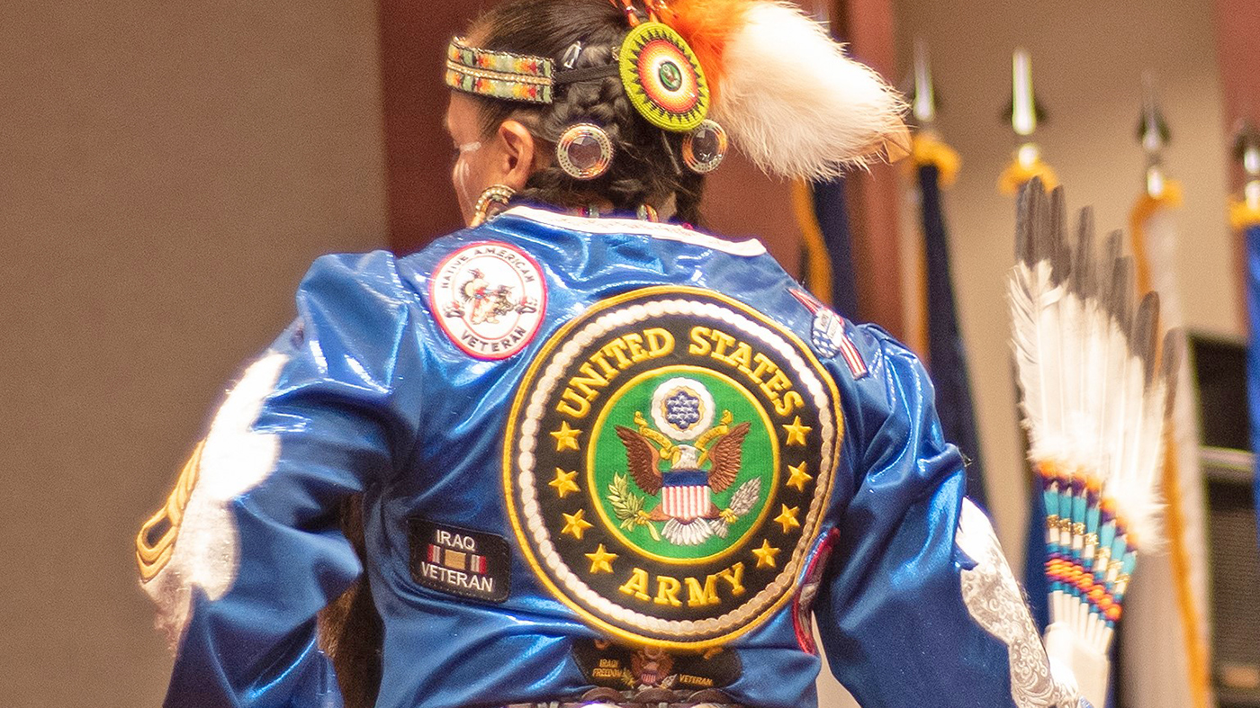 Native American woman with military logo jacket