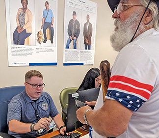 VA employee assists Veteran with PACT Act information