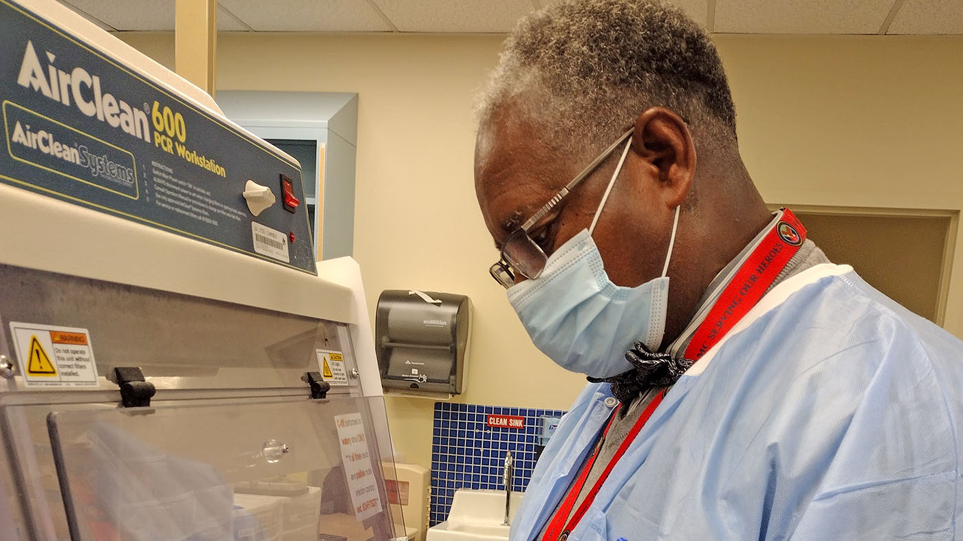 Technician uses colon health testing equipment