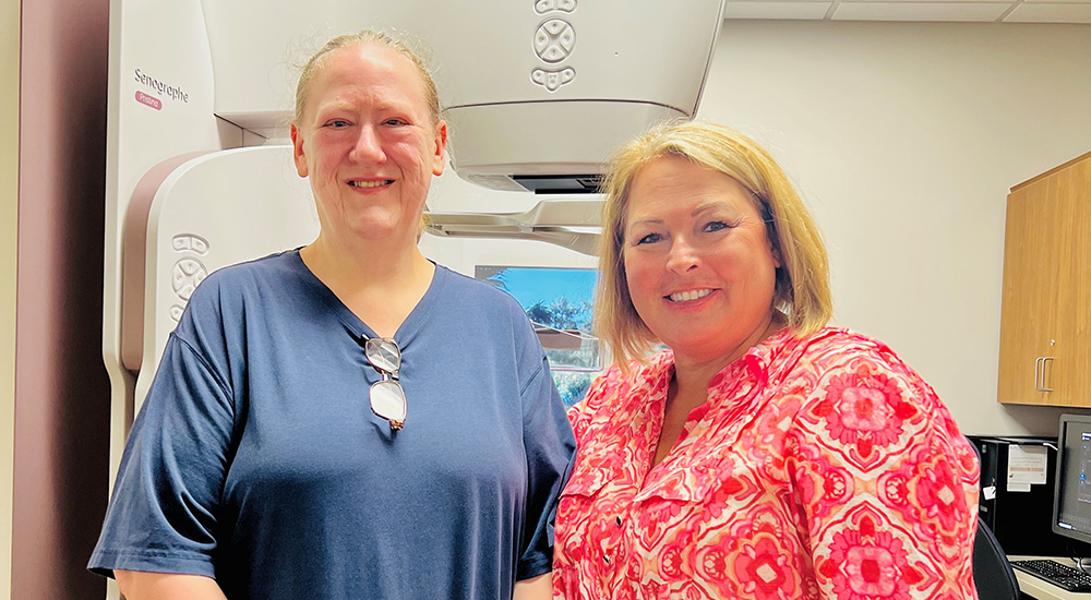 Two women after mammogram; mammography unit