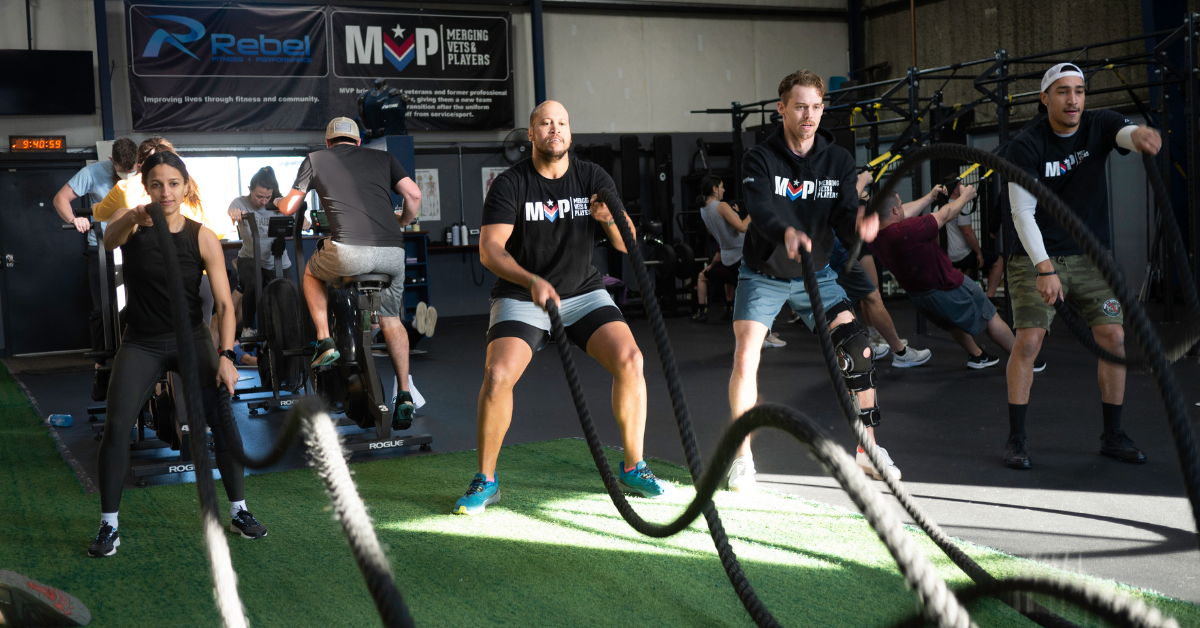 Men and women working out with battle ropes