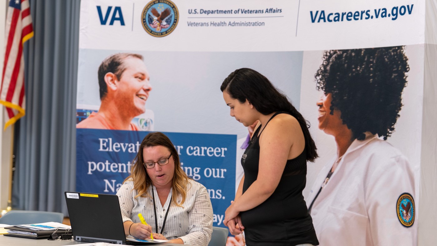 A hiring manager explains the application process to a future VA employee.