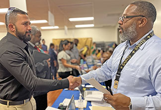 Job fair candidate shakes hands with HR staff