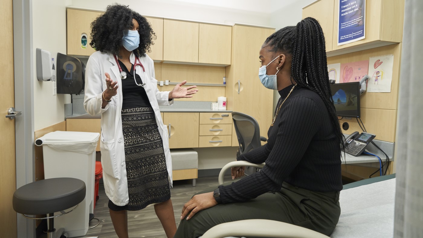 A Black VA physician discusses treatment with a Black patient.