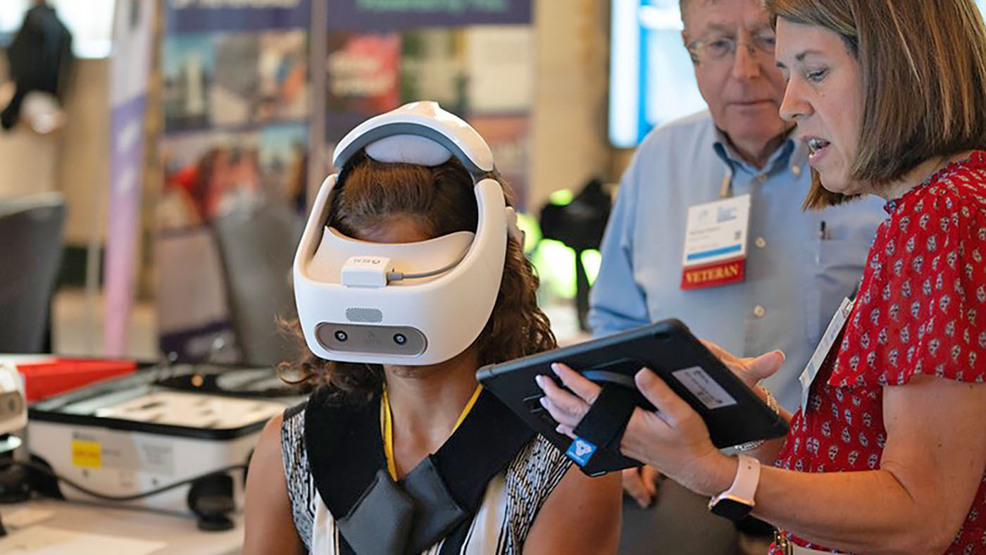 Immersive Summit attendee participates in technology demos