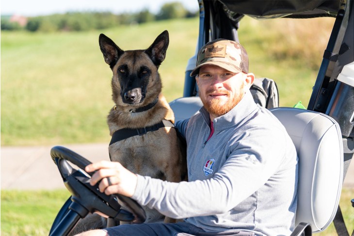 Leashes of Valor and Valor Cup photo: Mike Betts, a Marine Corps Veteran, with his service dog, Tesla, at the Valor Cup in 2022. Mike received Tesla, a rescue dog, from Leashes of Valor, and has since become an active volunteer with both LOV and the Valor Cup.