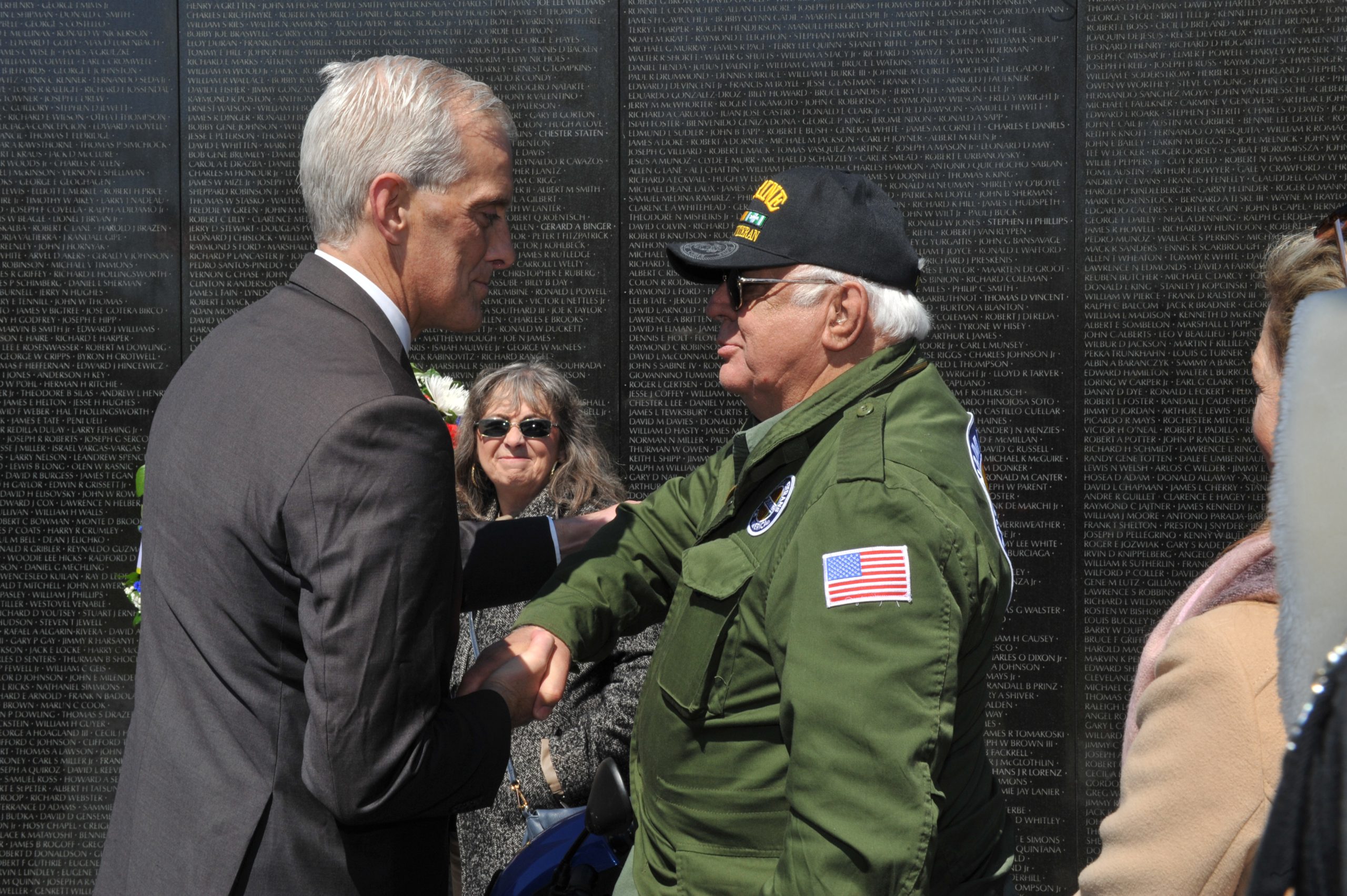 VA Secretary Denis McDonough shakes hands with a Veteran.