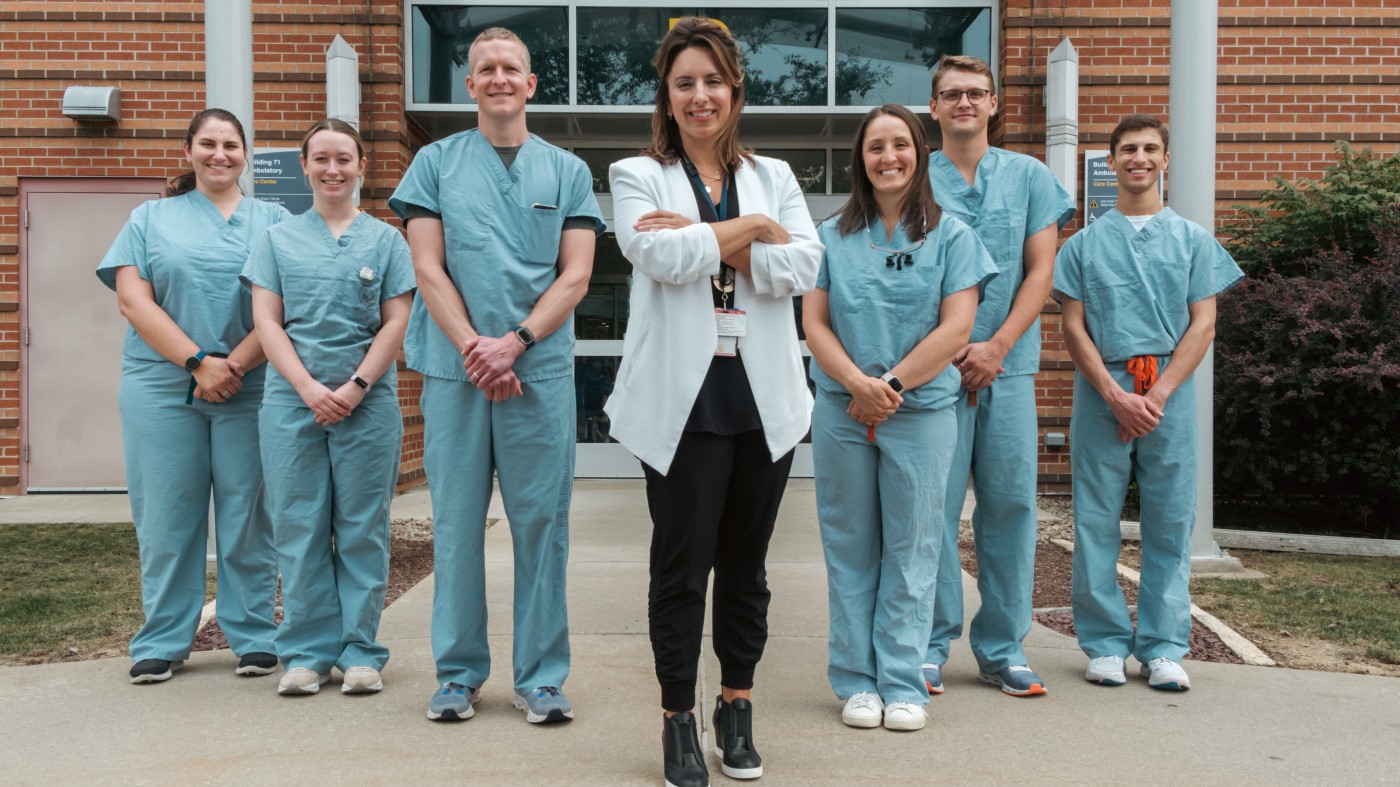 A team of primary care professionals outside a VA facility.