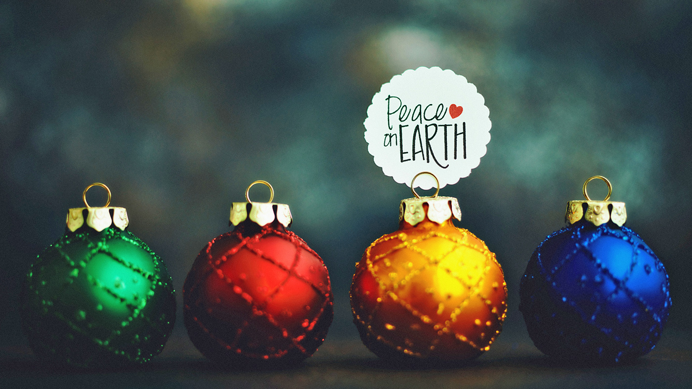 Two Christmas ornaments with Peace on Earth sign