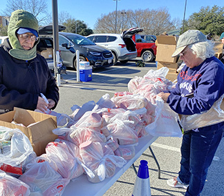 Community volunteers pack food