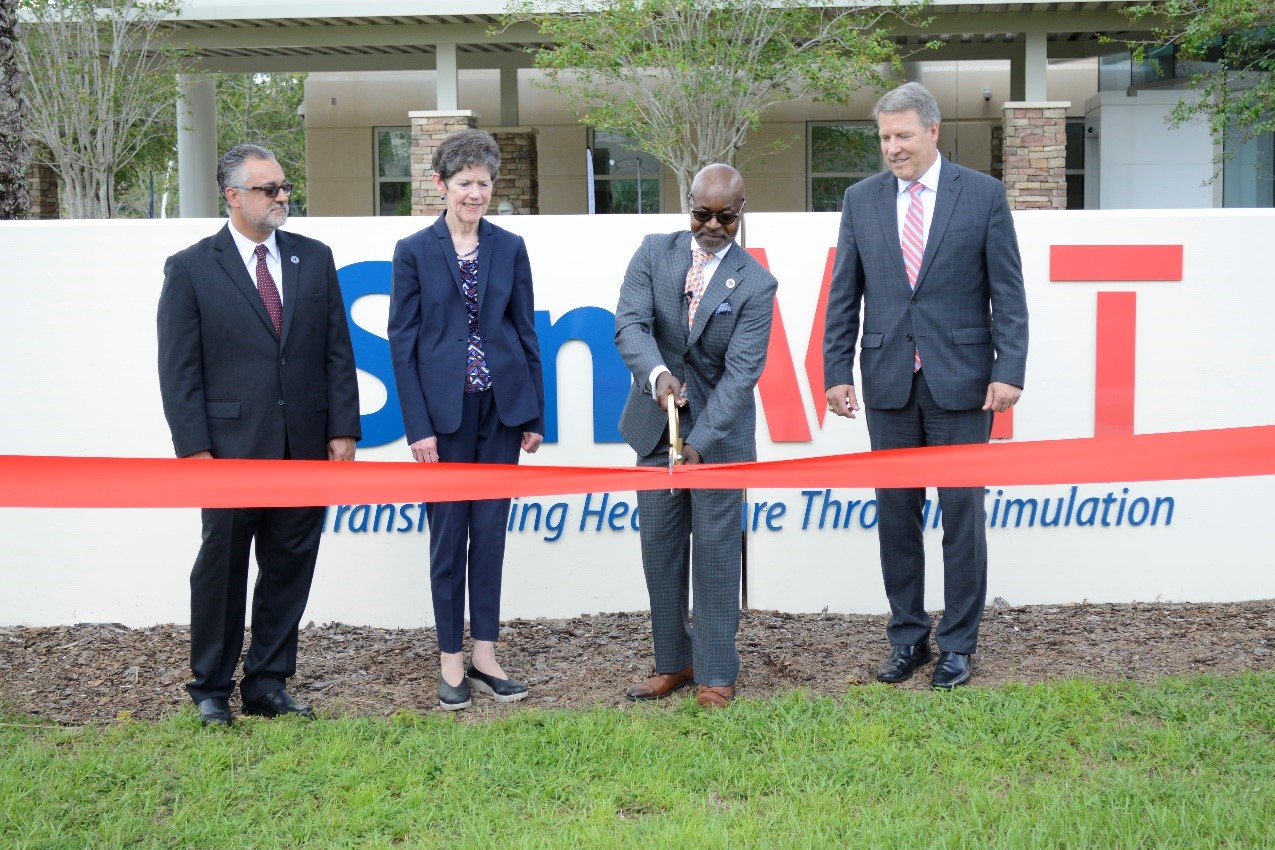 (From left to right) SimLEARN Medical Director Dr. Scott Wiltz, VHA Assistant Under Secretary of Health for Discovery. Education and Affiliate Networks Dr. Carolyn Clancy SimLEARN Executive Director Eric Bruns and Chief Acquisition Officer and Principal Executive Director for the Office of Acquisition, Logistics, and Construction (OALC) Michael D. Parrish cut ribbon to unveil the National SimVET Center in Orlando, Florida.
