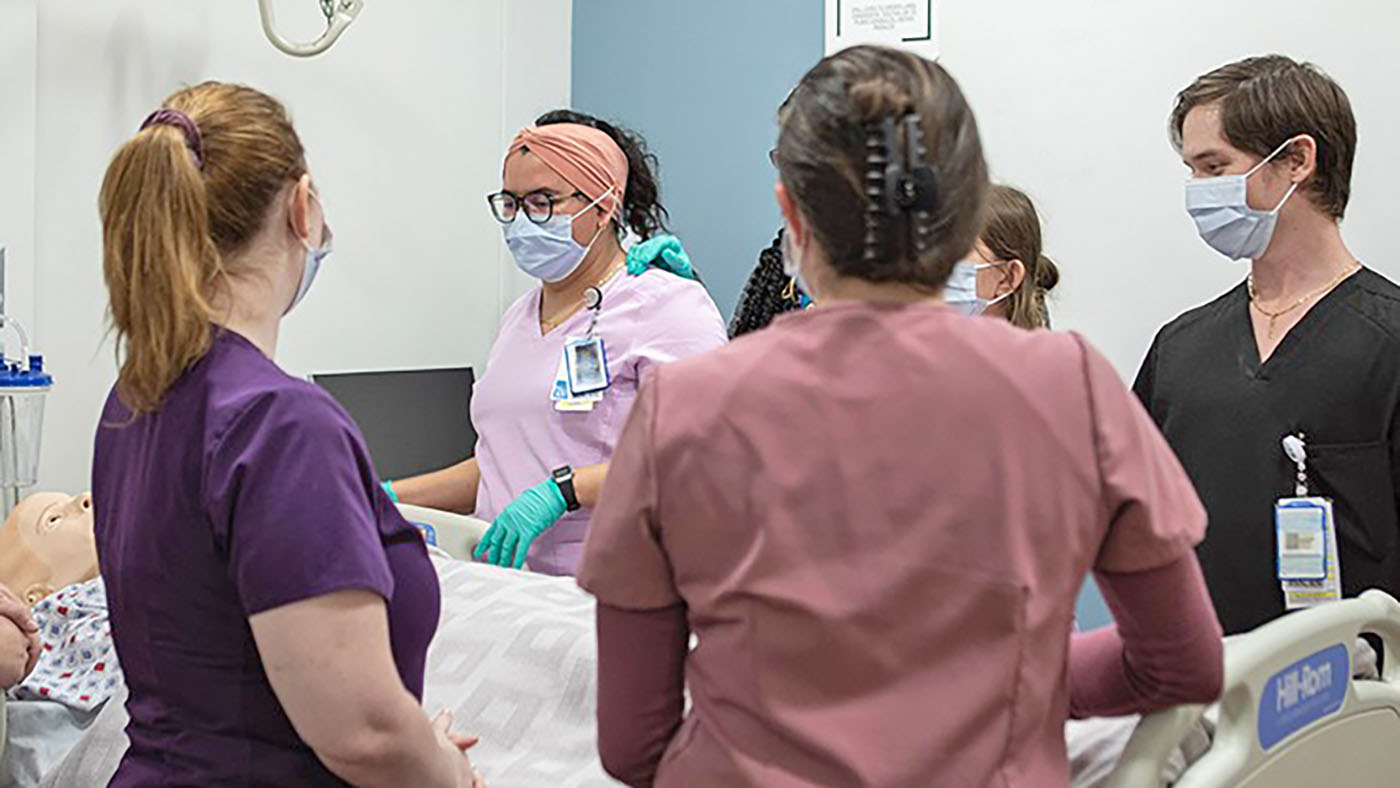 Nurse residents treat a practice patient during a simulation; telestroke