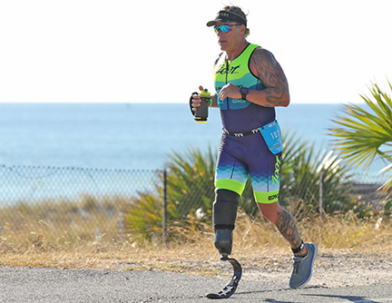 Veteran with prosthetic limb runs triathlon
