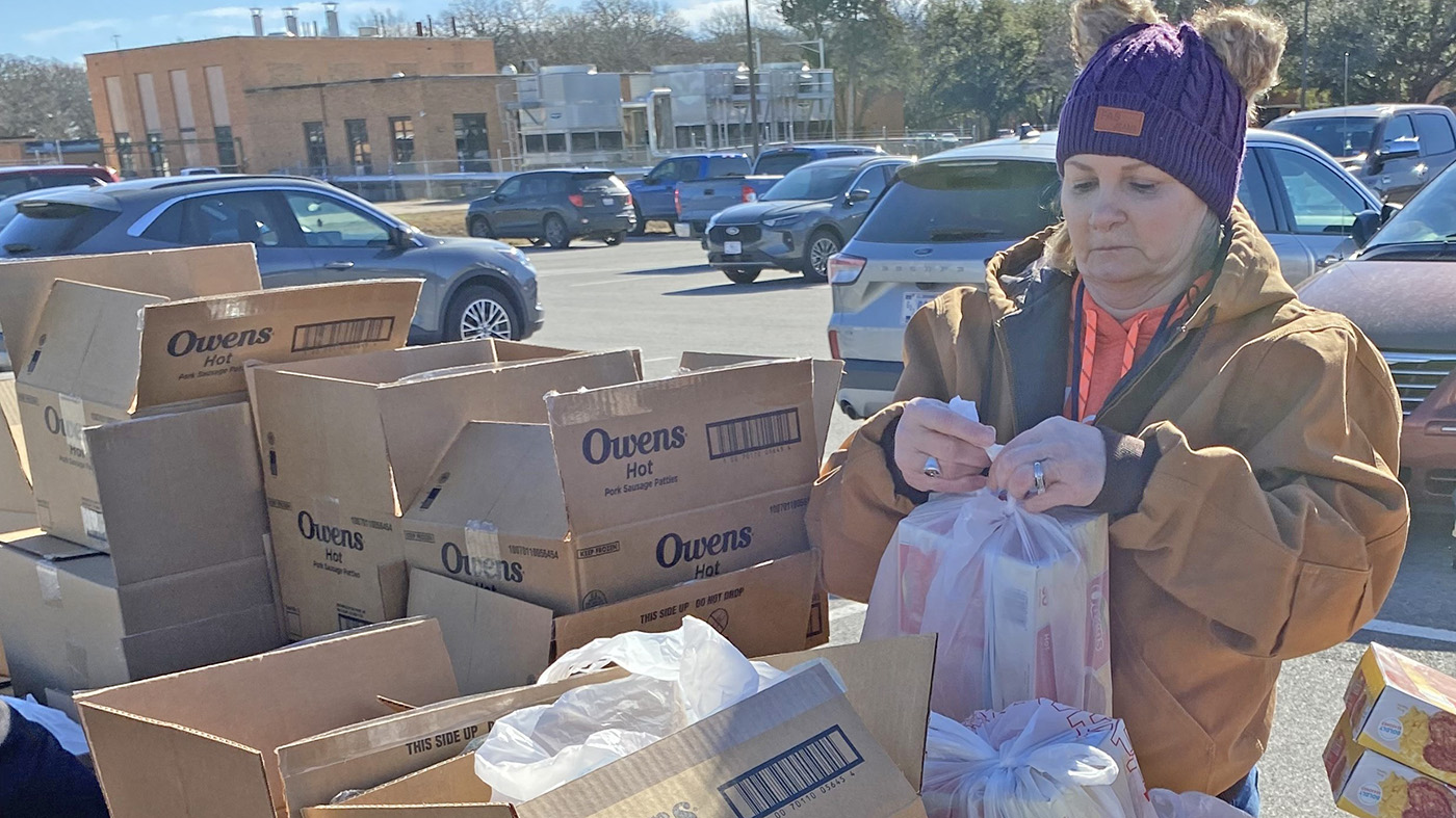 Community volunteer packs food
