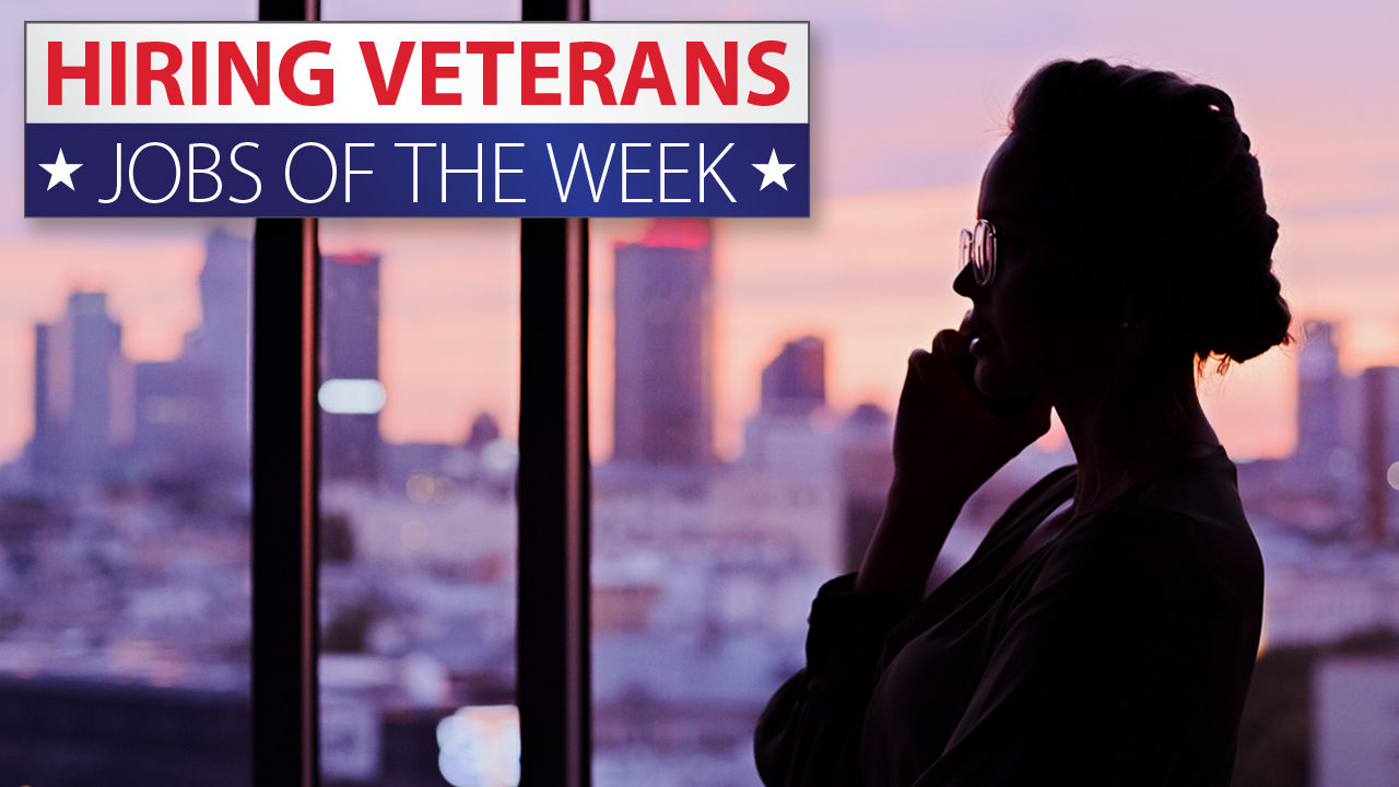 Hiring Veterans. Jobs of the week. Woman on phone looking out of high rise building office window.