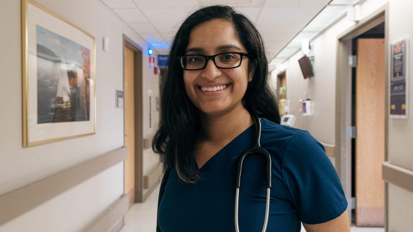 A physician resident in a hallway inside a VA facility.