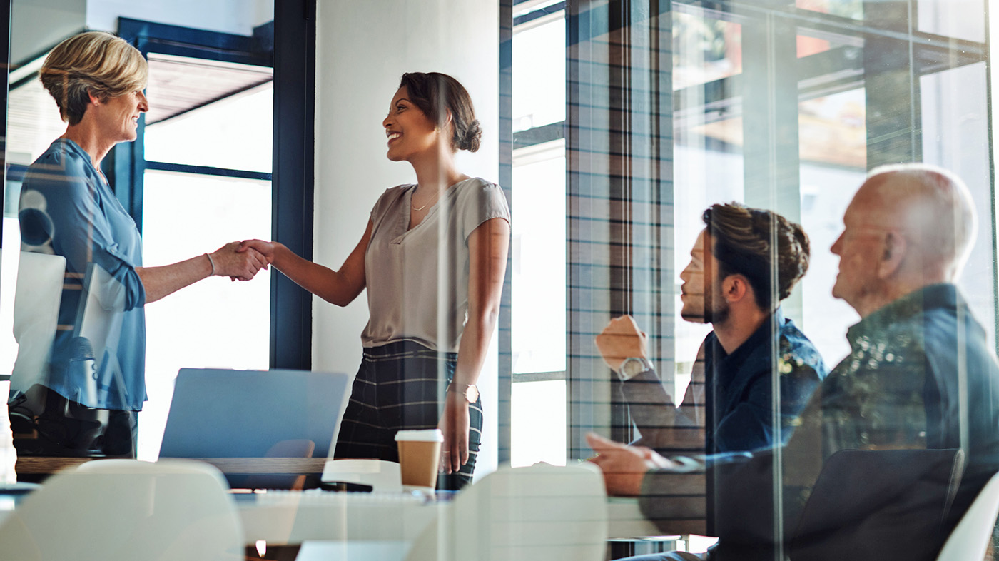 Two women shake hands; Salesforce