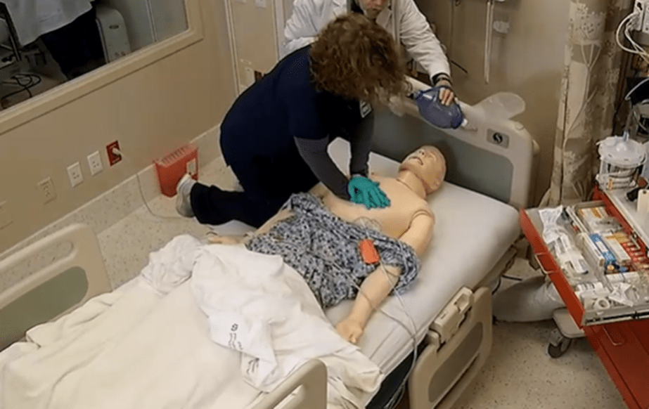 A woman trains for resuscitation during SimLEARN's RQI training.