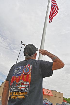 Marine Veteran salutes American flag