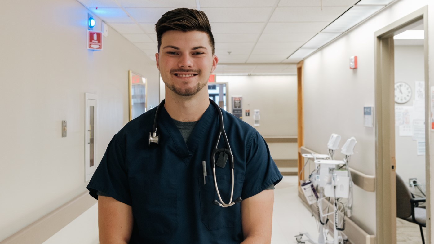 A VA nursing assistant in the hallway of a VA facility.