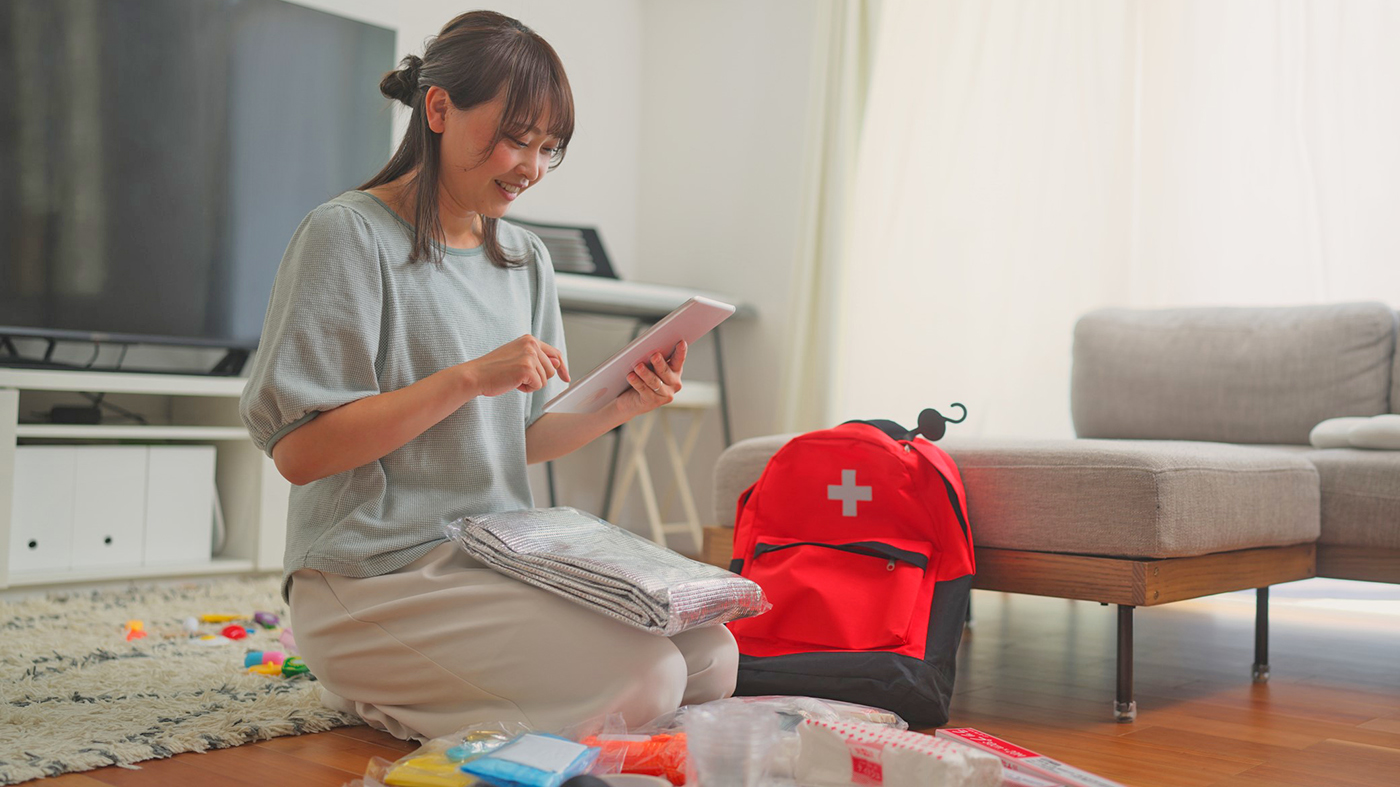 Woman prepares bag; emergency; hurricane season